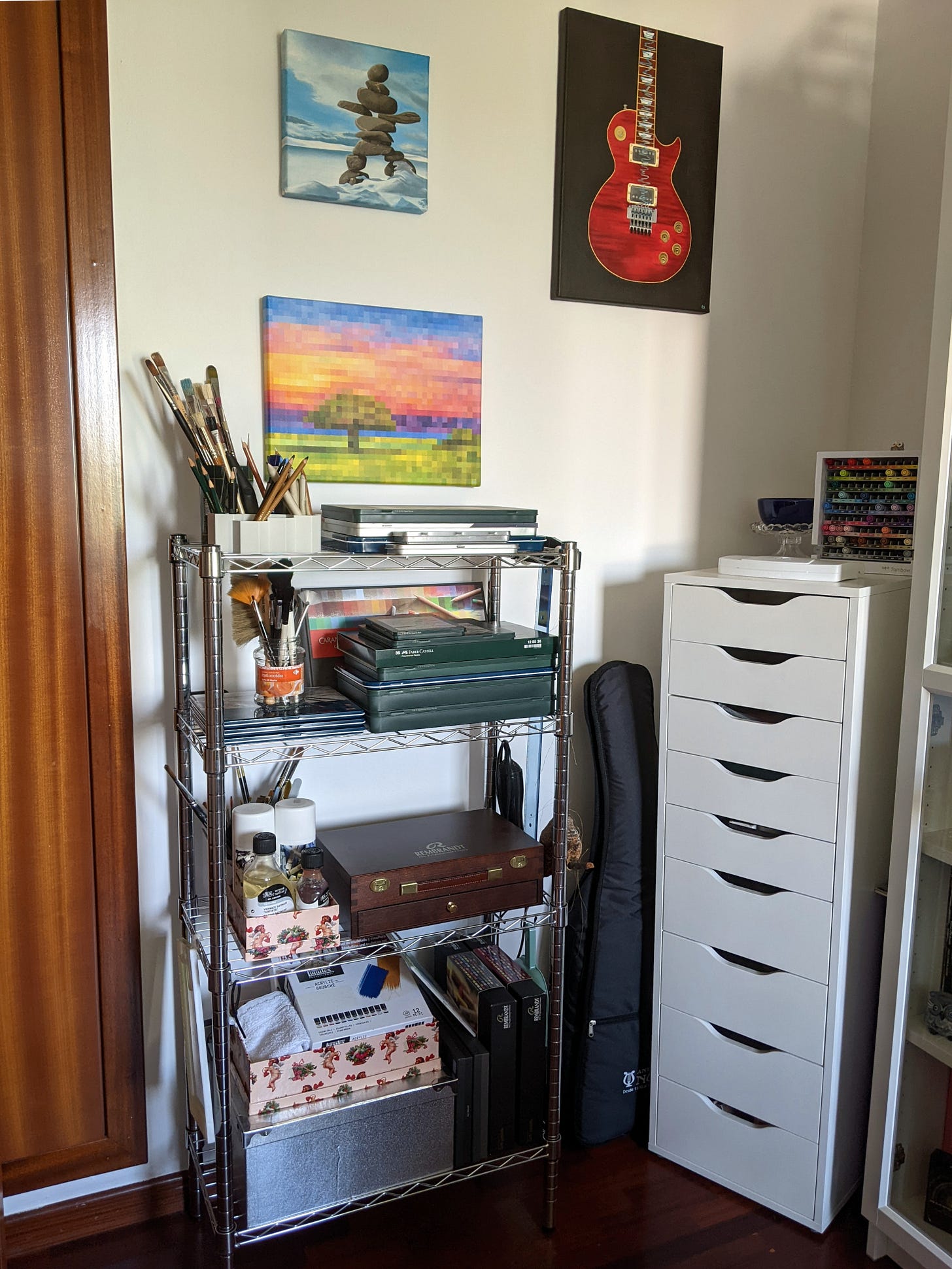 Corner of a room with artworks and art supplies.