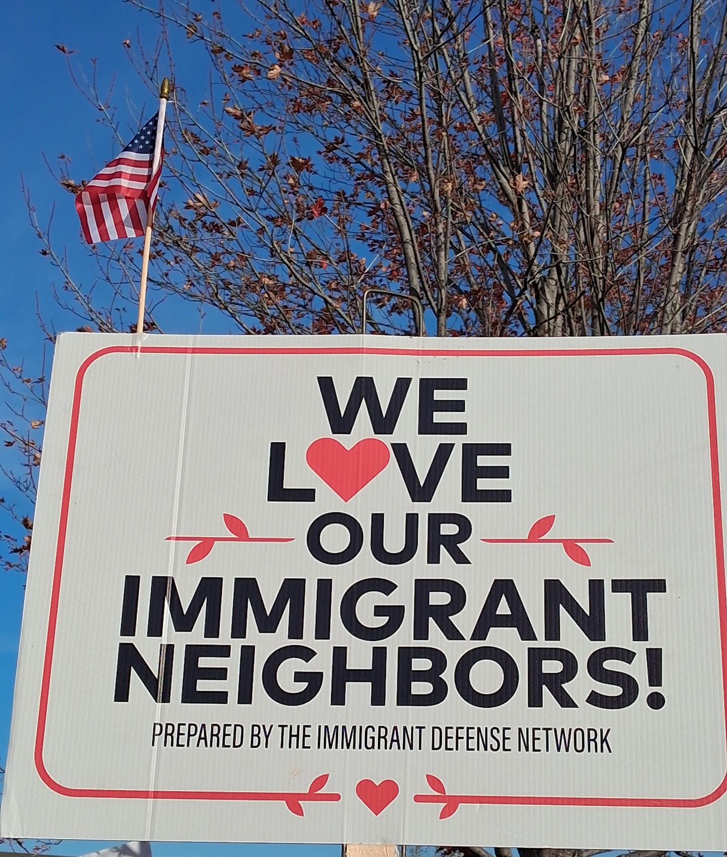 Protest Sign that says "We Love Our Immigrant Neighbors"