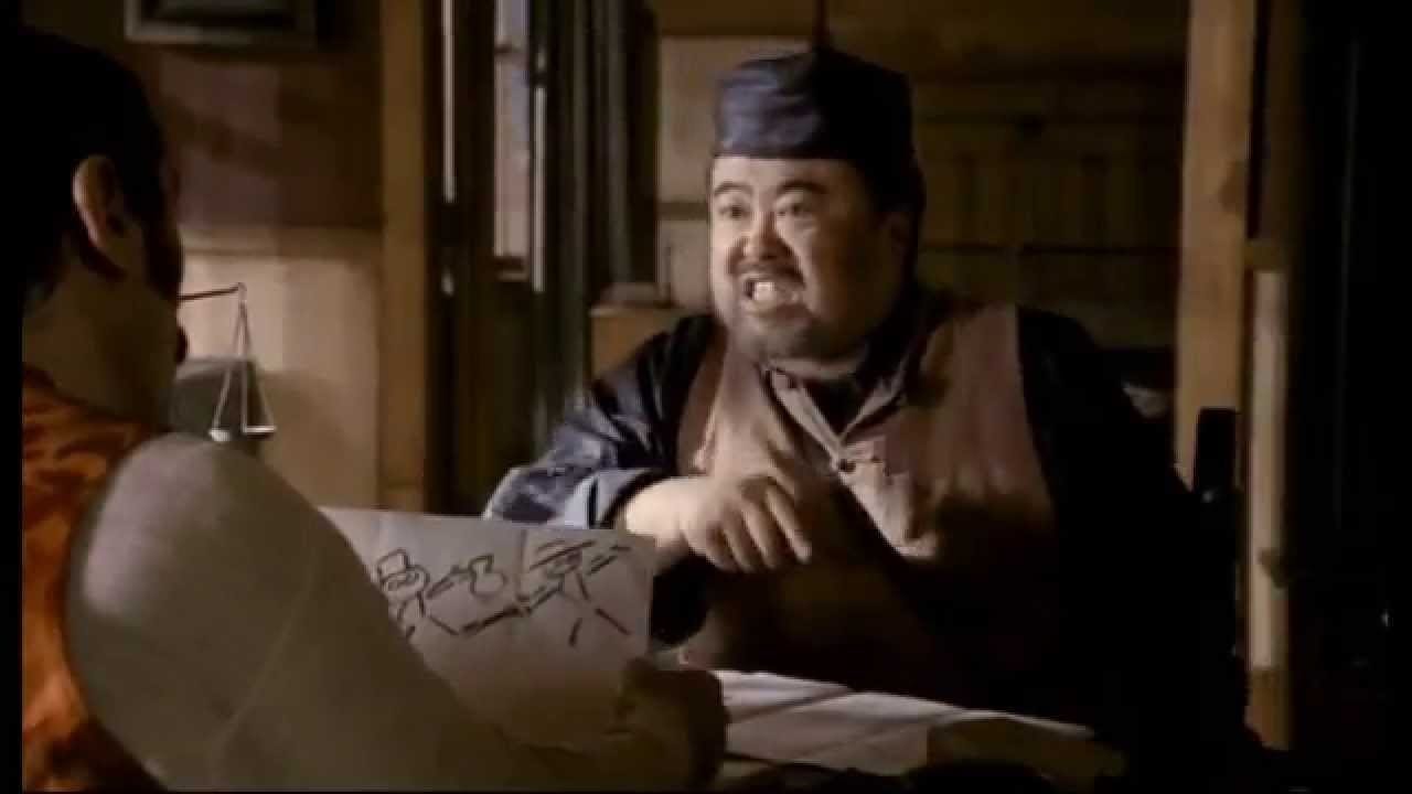 This image shows Mr. Wu (played by Keone Young) yelling at Al Swearengen (played by Ian McShane, whose back is to camera) while sitting at Al's desk inside Al's Gem Saloon office. This image shows Mr. Wu (played by Keone Young) yelling at Al Swearengen (played by Ian McShane, whose back is to camera) while sitting at Al's desk inside Al's Gem Saloon office.