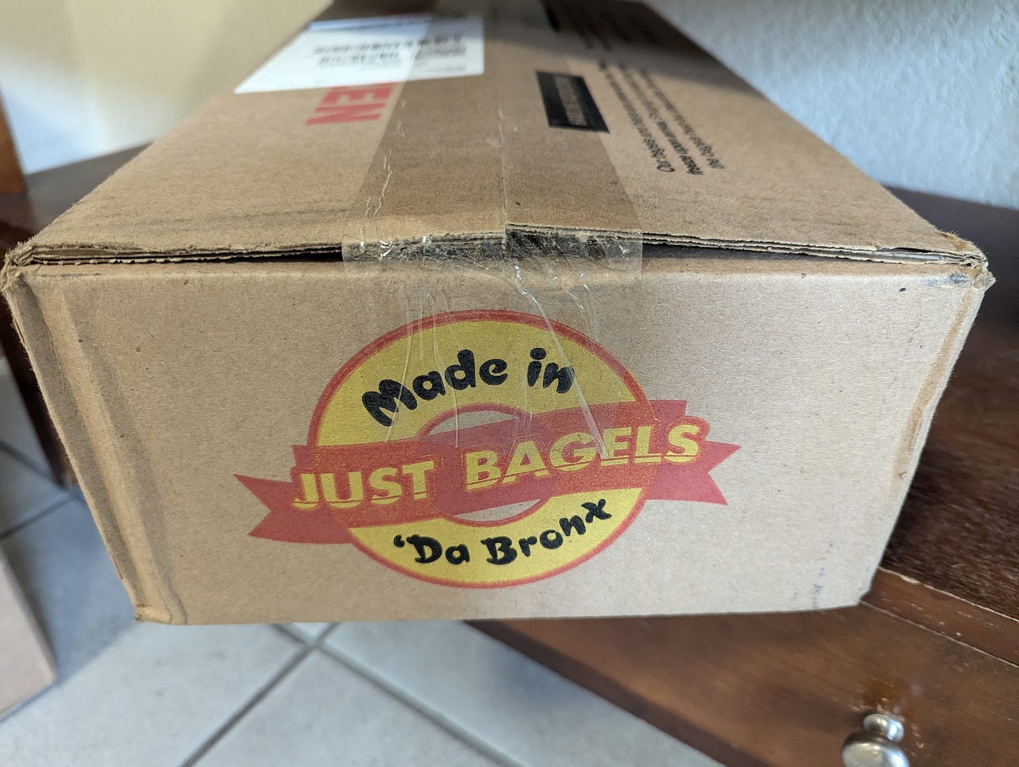 Brown box with JUST BAGELS logo Brown box with JUST BAGELS logo