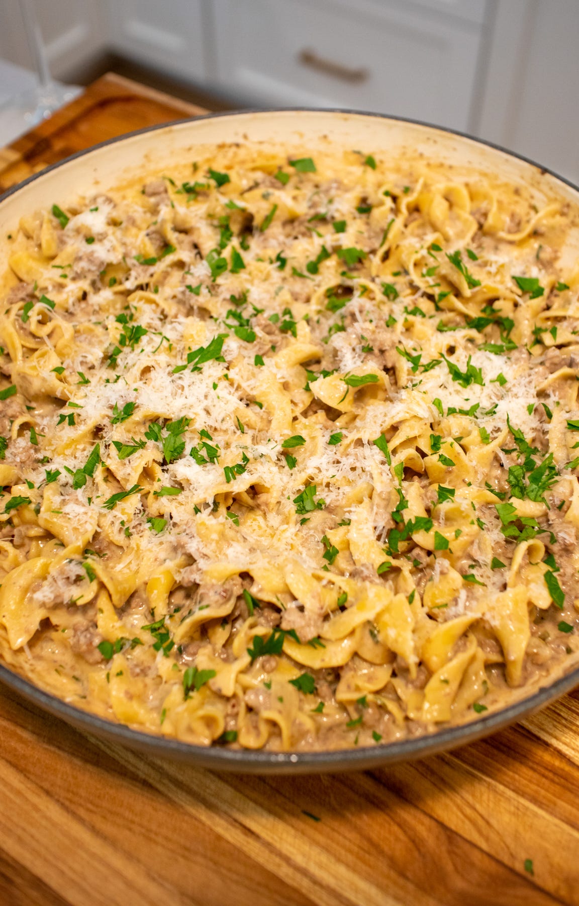 One pot beef stroganoff in a wide braiser with egg noodles coated in a creamy sauce.