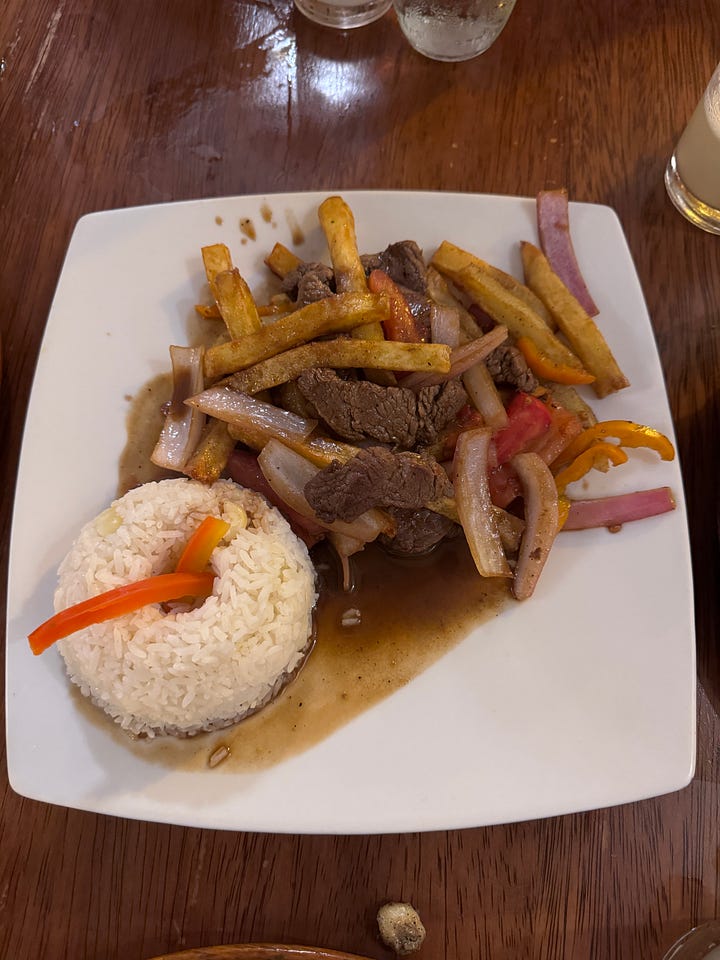 Lomo saltado, seco de res, an appetizer platter for two (armies), pisco sour