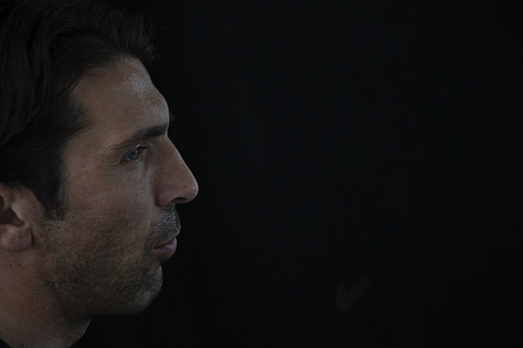 Gianluigi Buffon during a filmed interview on May 12, 2012: shown smiling, speaking, in profile, gesturing with emphasis, and seated against a black background.
