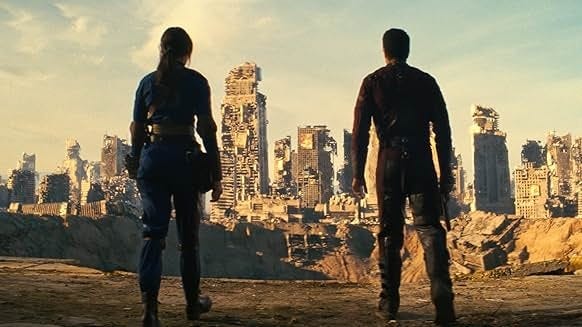 Ella Purnell as Lucy MacLean and Aaron Moten as Maximus looking at the destruction of Shady Sands in Fallout, 2024