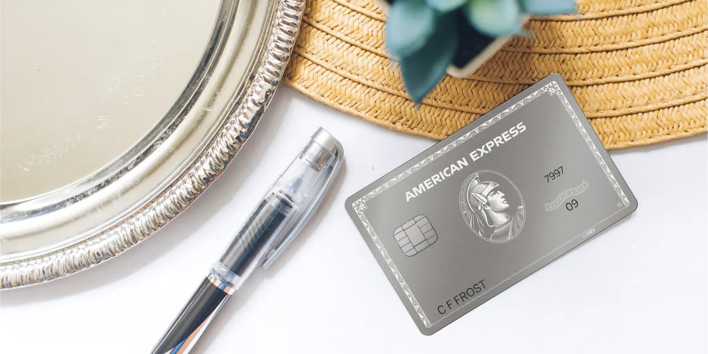 Amex Platinum mirror card on table with a pen and plate