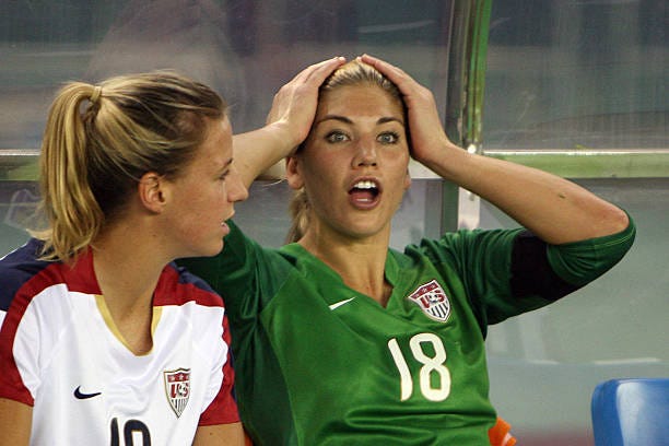 Replaced US goalkeeper Hope Solo sits on the bench with teammate Aly Wagner before losing their 2007 FIFA Women's World Cup football tournament... Replaced US goalkeeper Hope Solo sits on the bench with teammate Aly Wagner before losing their 2007 FIFA Women's World Cup football tournament...