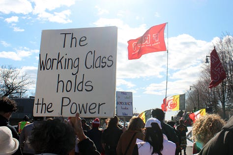 Left image: one small square pink poster reading "I support unions" and a person in a red cap holds up a poster in rainbow lettering "this is what DEMOCRACY looks like." Middle image: A young Brown man stands to the left of the image facing right holding a microphone and cellphone, a white person with short brown hair and a black shirt stands looking downward in the right corner. Right image: a white poster with black text that reads "The working class holds the power" and a red flag with the letters FRSO (Freedom Road Social Organization) flies in the background