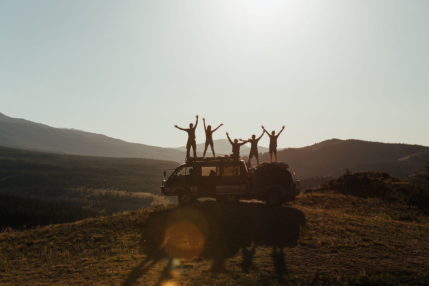 Group of people on van enjoying a scenic mountain view at sunrise, embracing freedom and adventure representing What Five Years Abroad Actually Looks Like by Kay Fabella on Edgewalkers Collective Group of people on van enjoying a scenic mountain view at sunrise, embracing freedom and adventure representing What Five Years Abroad Actually Looks Like by Kay Fabella on Edgewalkers Collective