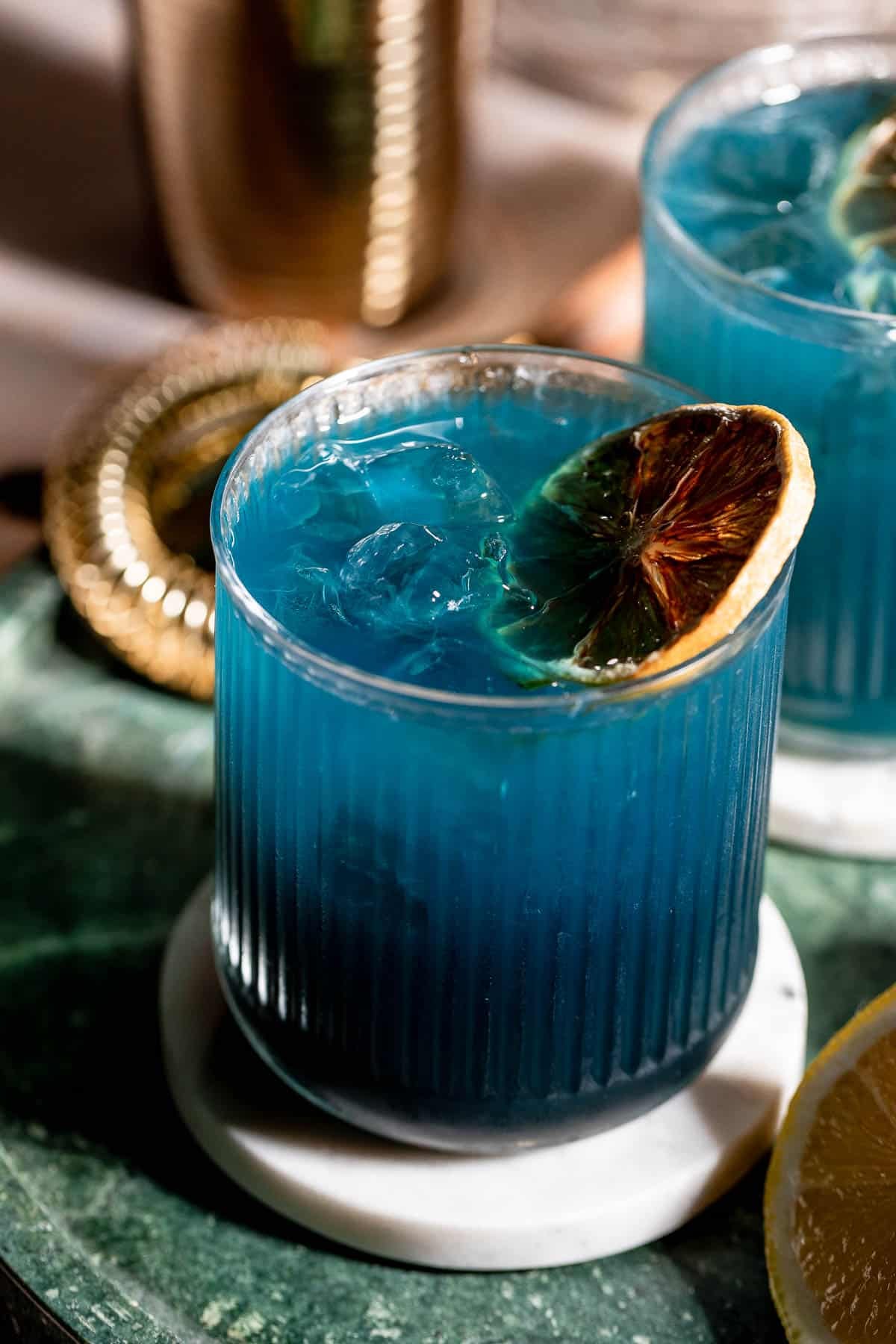 black opal cocktail on marble coasters 