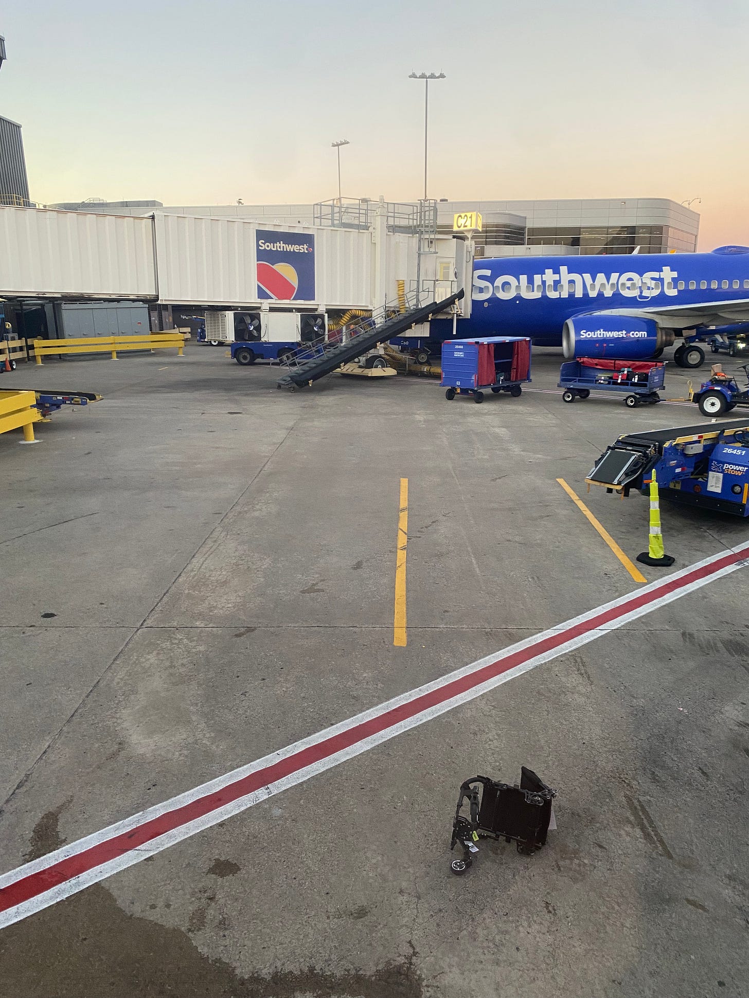 a lone wheelchair frame left on a tarmac/apron..