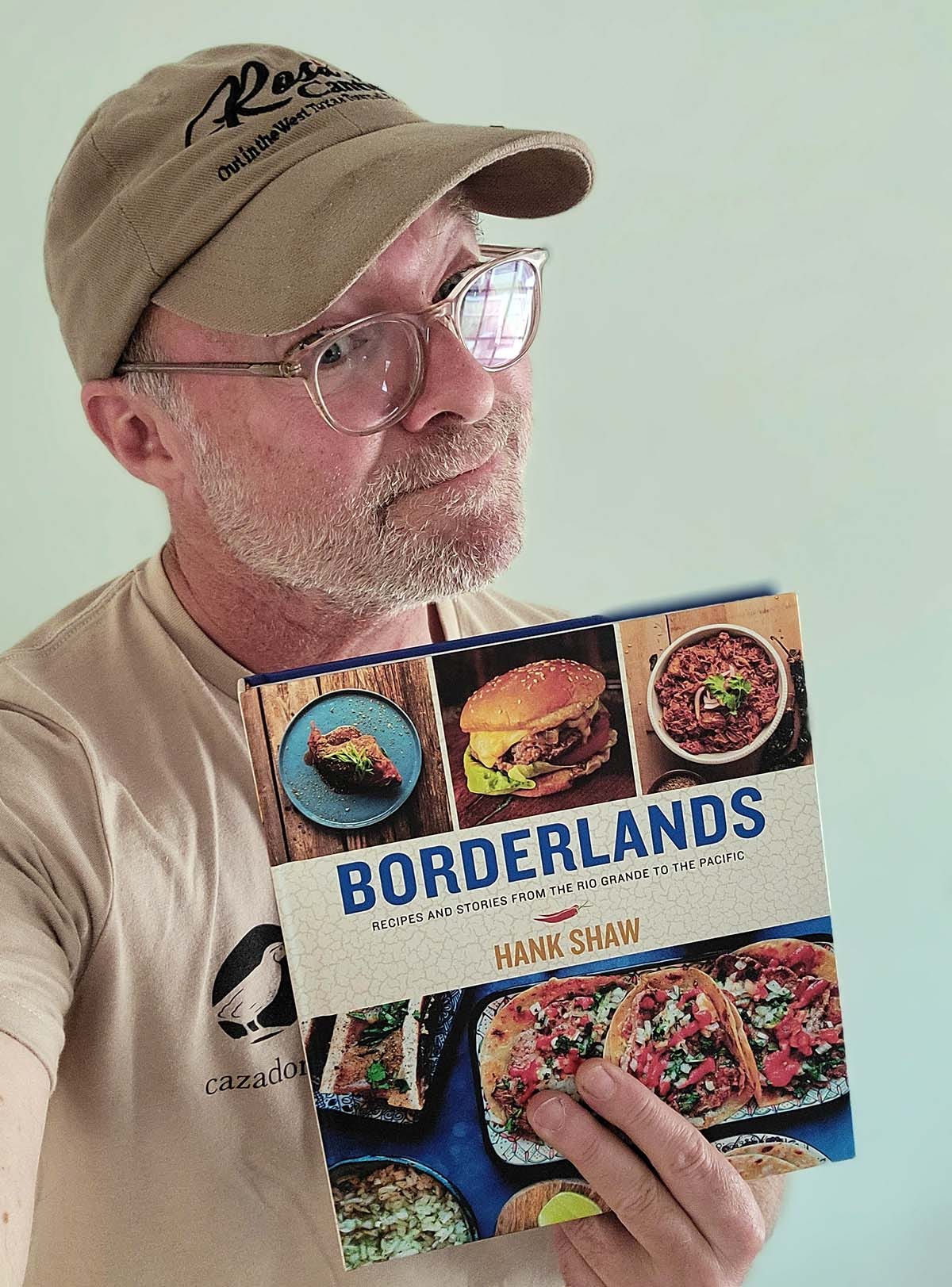 Hank Shaw holding a copy of Borderlands. 