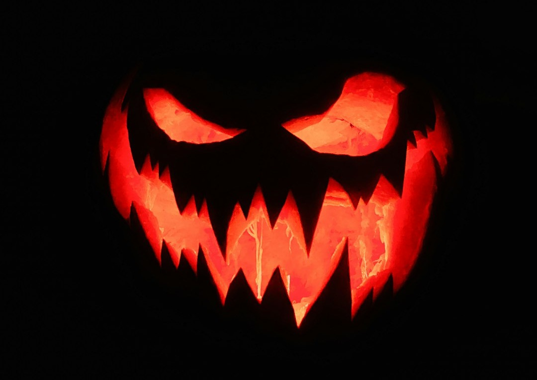 a lit up jack o lantern in the dark