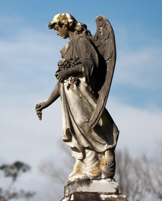 angel grey statue at daytime
