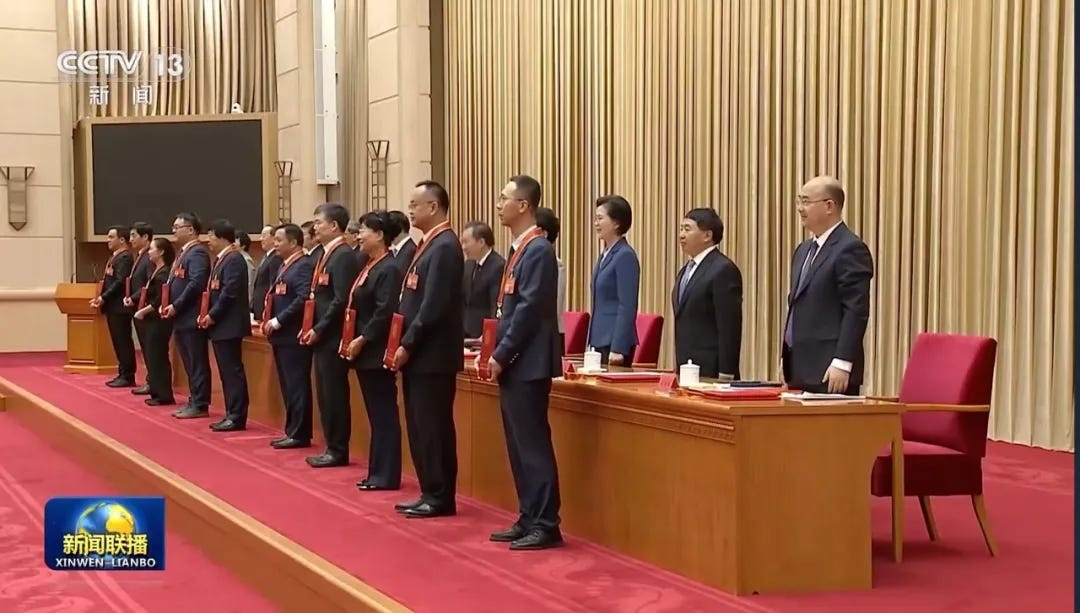 Liu Baiqi, stood in front of the desk closest to the camera, receiving the title ‘Outstanding Builders of Socialism with Chinese Characteristics’ on July 29th. Liu Baiqi, stood in front of the desk closest to the camera, receiving the title ‘Outstanding Builders of Socialism with Chinese Characteristics’ on July 29th.