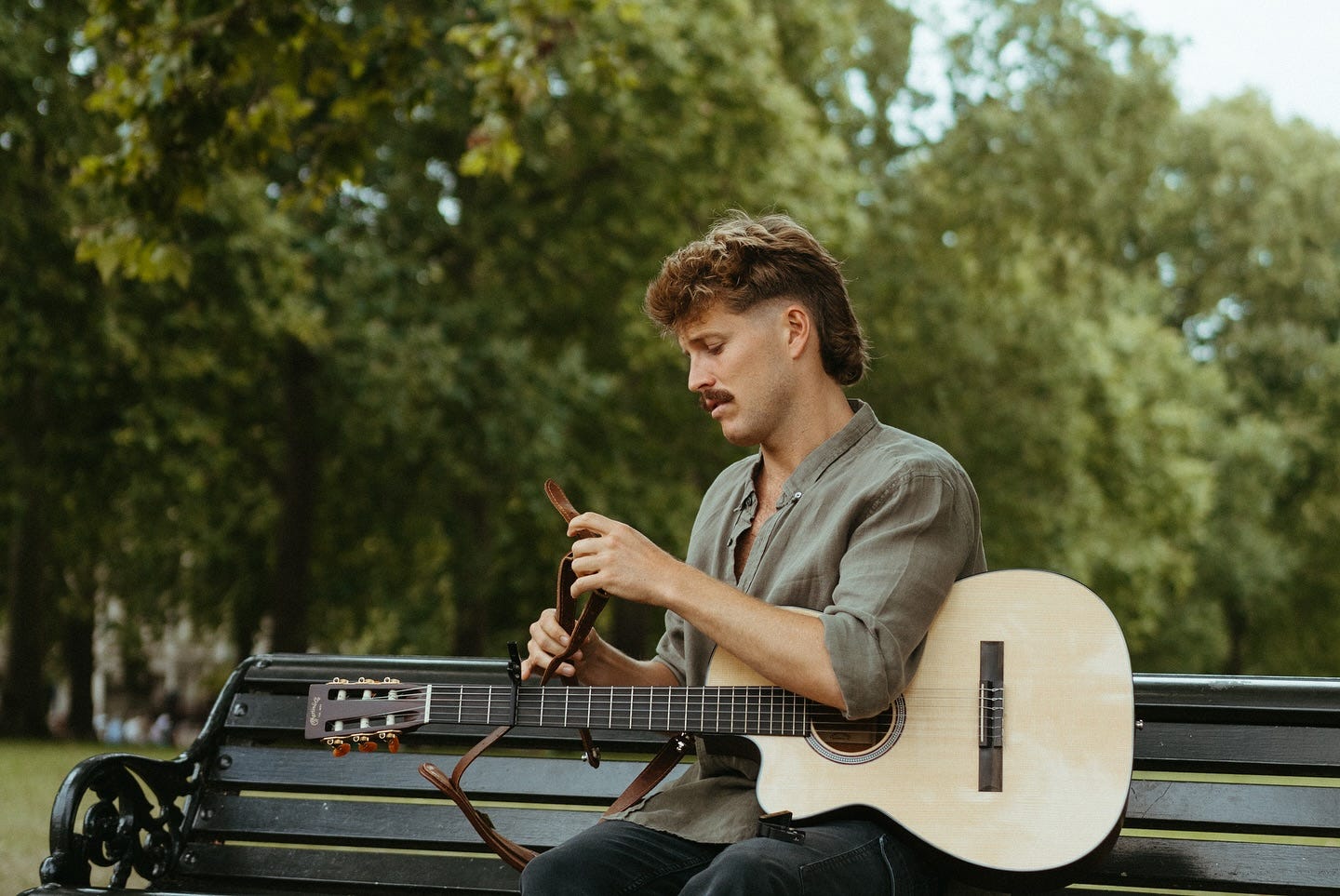 May be an image of 1 person, guitar and grass