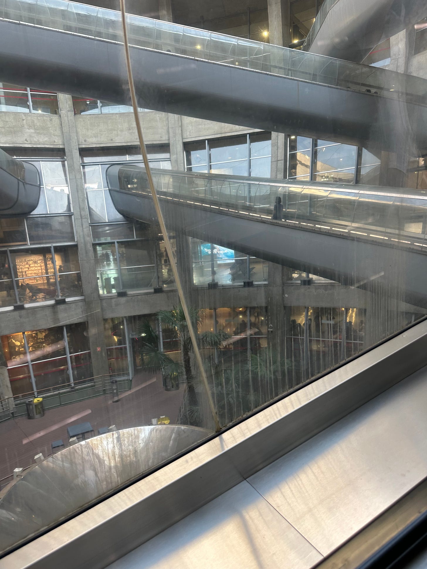 The habitrail looking escalator ramp tubes through the circular building at Charles De Gaul’s terminal one building which also features on the cover of the Alan Parsons Project album, I Robot