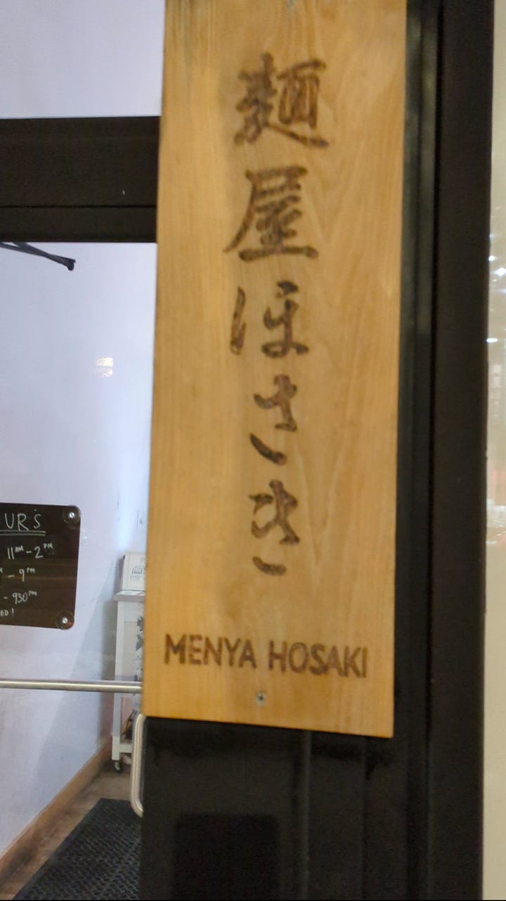 Line down the block on a tuesday at 11am and the subtle sign outside menya hosaki