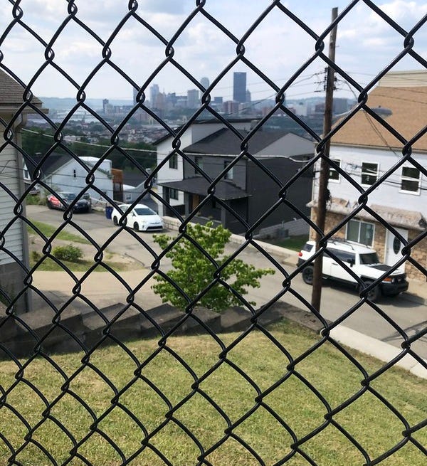 Looking through the park's chain link fence to downtown Pittsburgh.