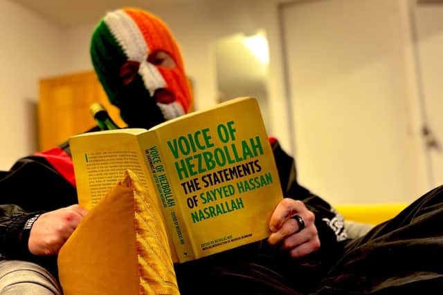 An image posted online by Kneecap showing Kneecap member DJ Provai reading the collected thoughts of Hezbollah leader Hassan Nasrallah. The group has now said it never supported Hezbollah