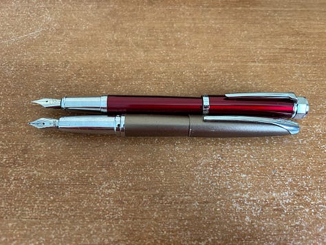 Two fountain pens laid out to compare the size of the Ellington Classic fountain pen with an older Cross Fountain pen