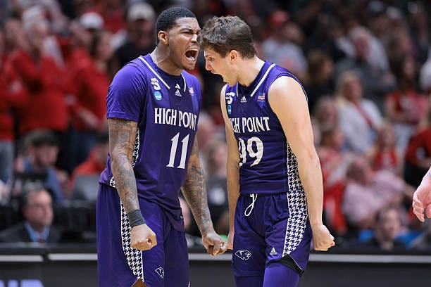 Forward Cam'ron Fletcher and guard Chase Johnston of the High Point Panthers react after taking the lead during the second half in the first round of...