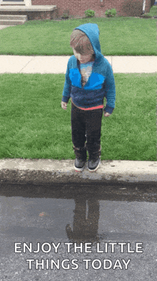 a little boy jumping into a puddle with the words enjoy the little things today a little boy jumping into a puddle with the words enjoy the little things today