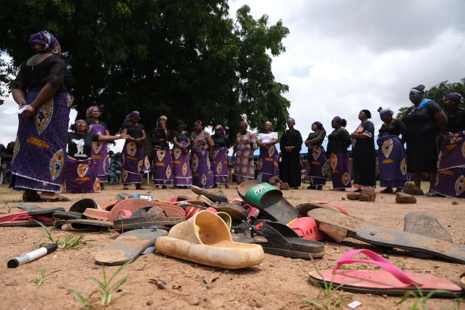 Women standing round sandals on the ground. Women standing round sandals on the ground.