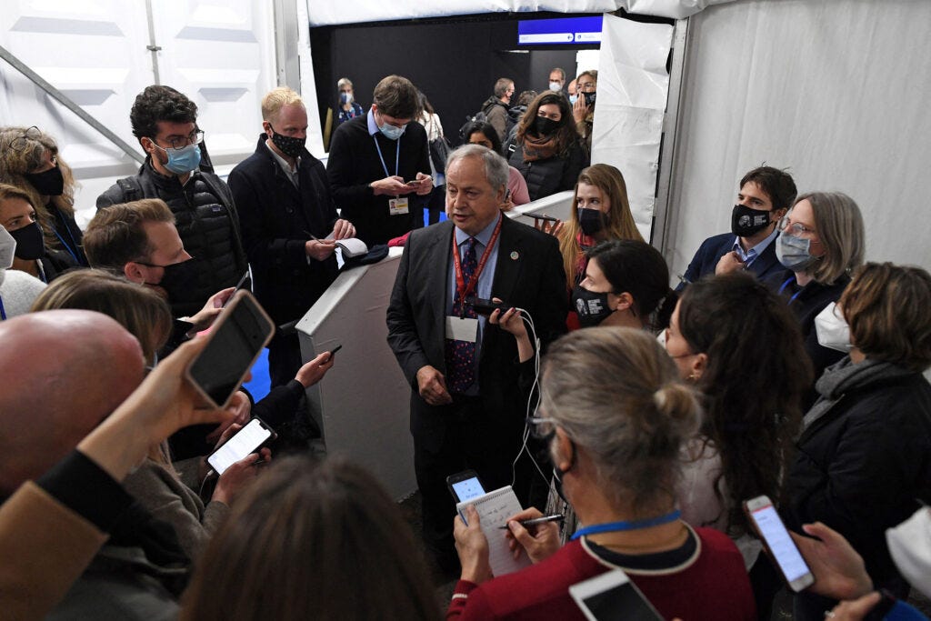 Alden Meyer (center) speaks to the media at COP26 in Glasgow. Credit: Paul Ellis/AFP via Getty Images