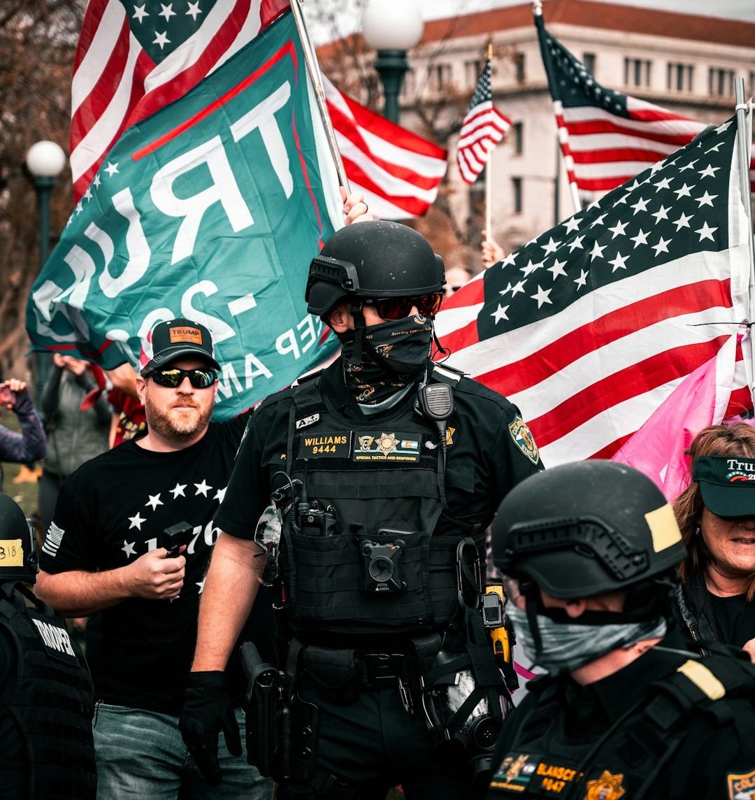 man in black police uniform holding us a flag