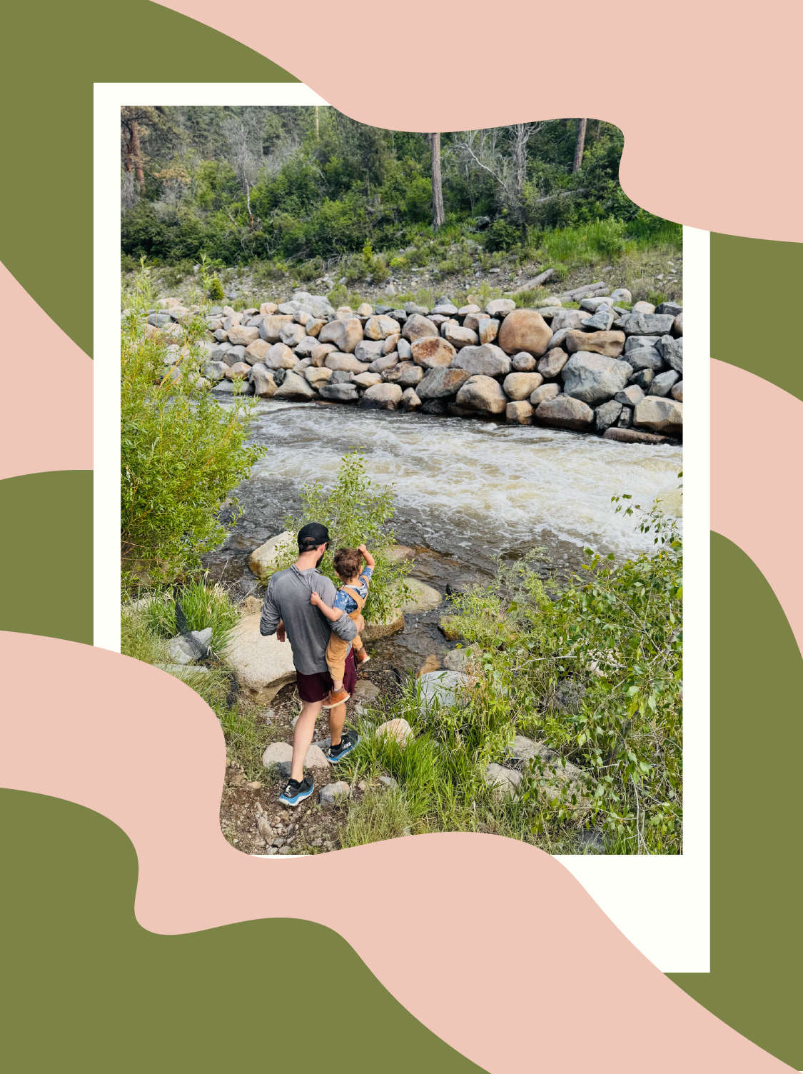 man and child standing by a river