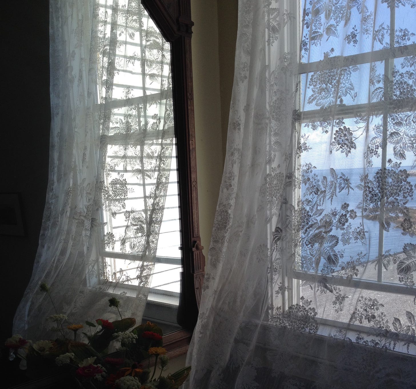 The breeze blowing through an open window, stirring the lace curtains. The breeze blowing through an open window, stirring the lace curtains.