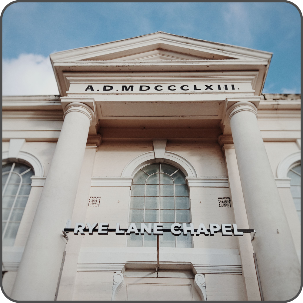 A cream-coloured church building, viewed from street level