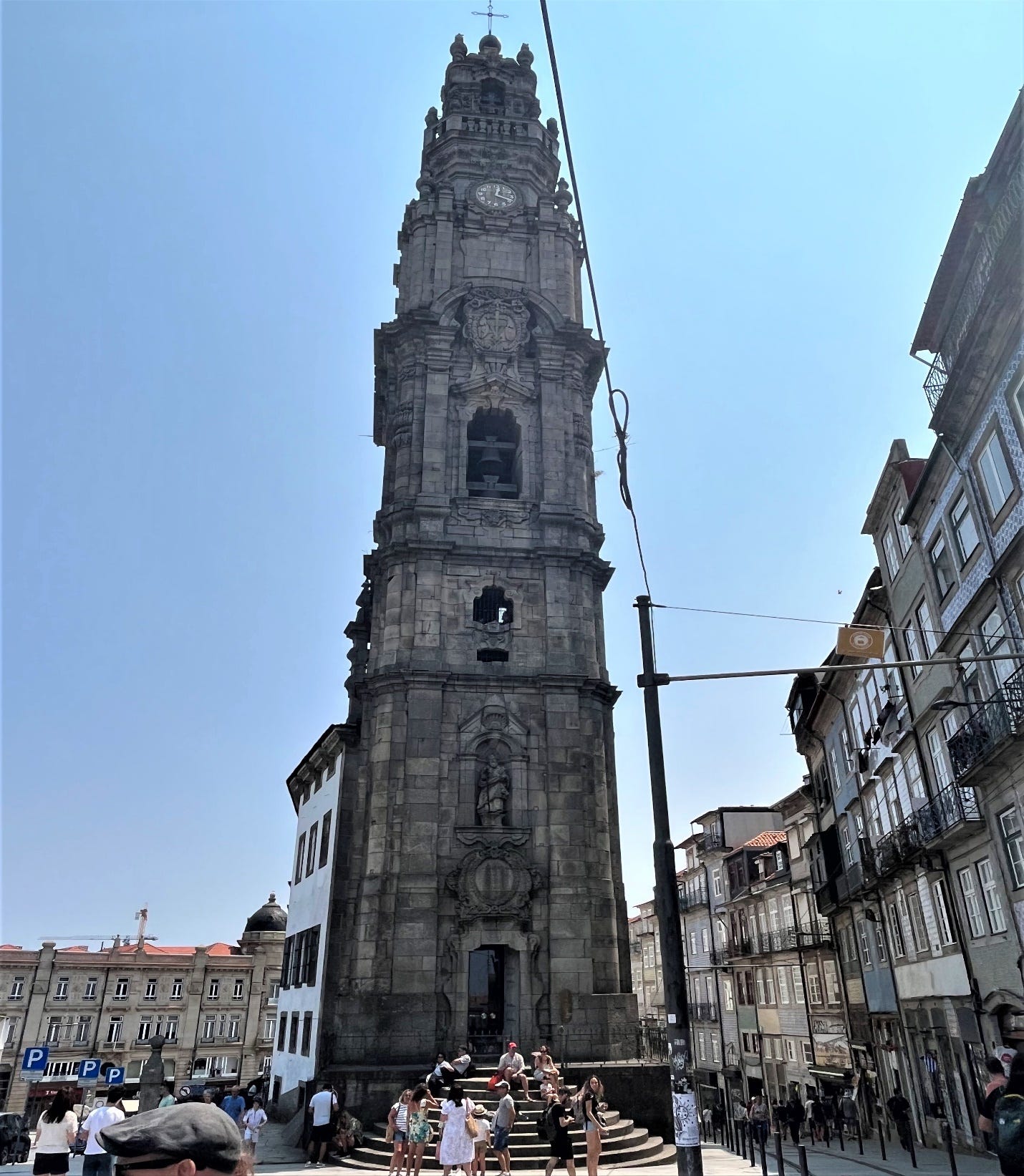 A tall stone tower with a clock on it

Description automatically generated