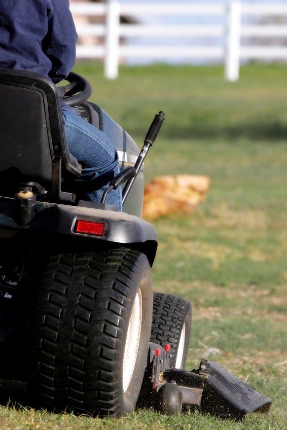 An image of a person on a riding lawn mower An image of a person on a riding lawn mower