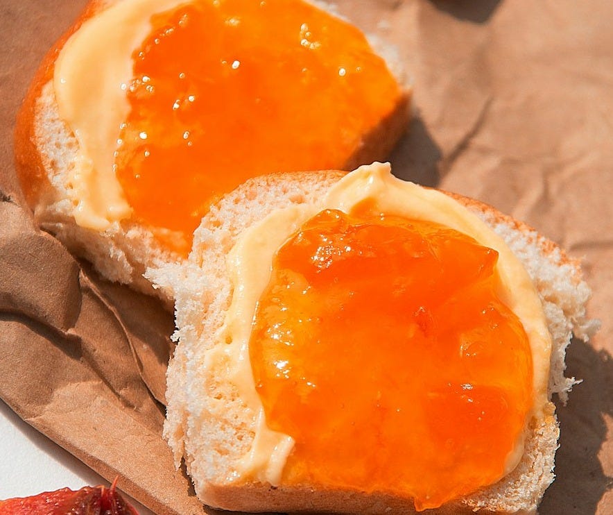 brown bread with white cream on brown paper