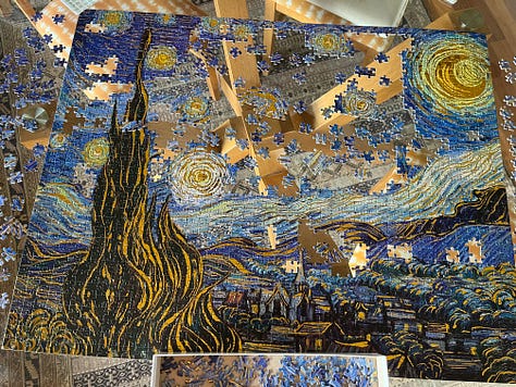 a jigsaw of the vincent van gogh painting starry starry night in various levels of completion. the final photo shows the four duplicate pieces included next to where they matched the puzzle.