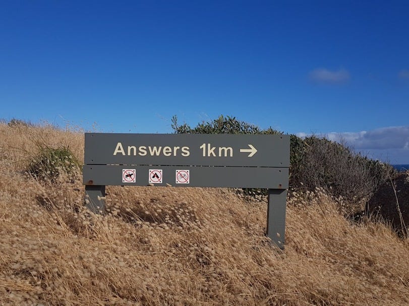 a sign that is on the side of a hill