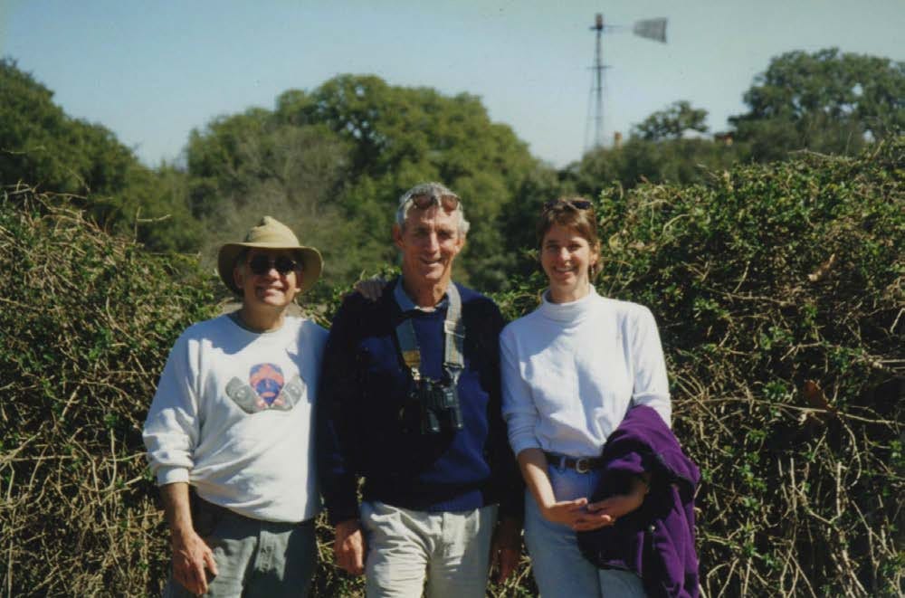 A group of people standing in front of bushes

AI-generated content may be incorrect.