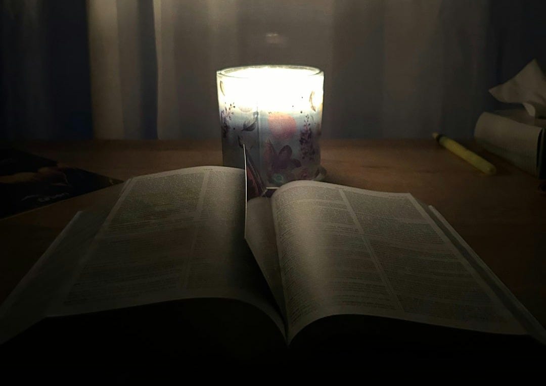 an open book sitting on top of a wooden table an open book sitting on top of a wooden table