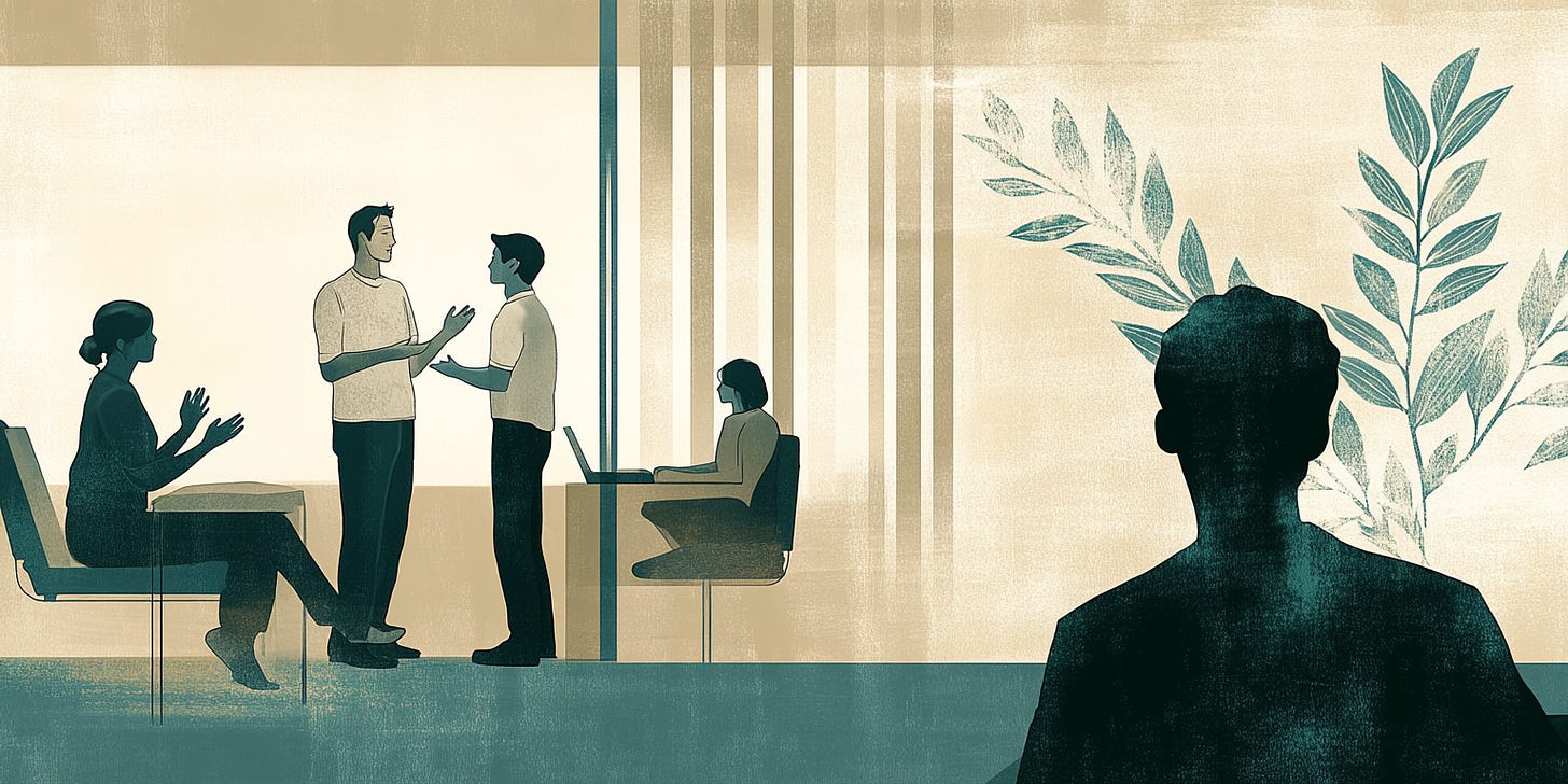 Four people in discussion, with another figure watching quietly from across the room