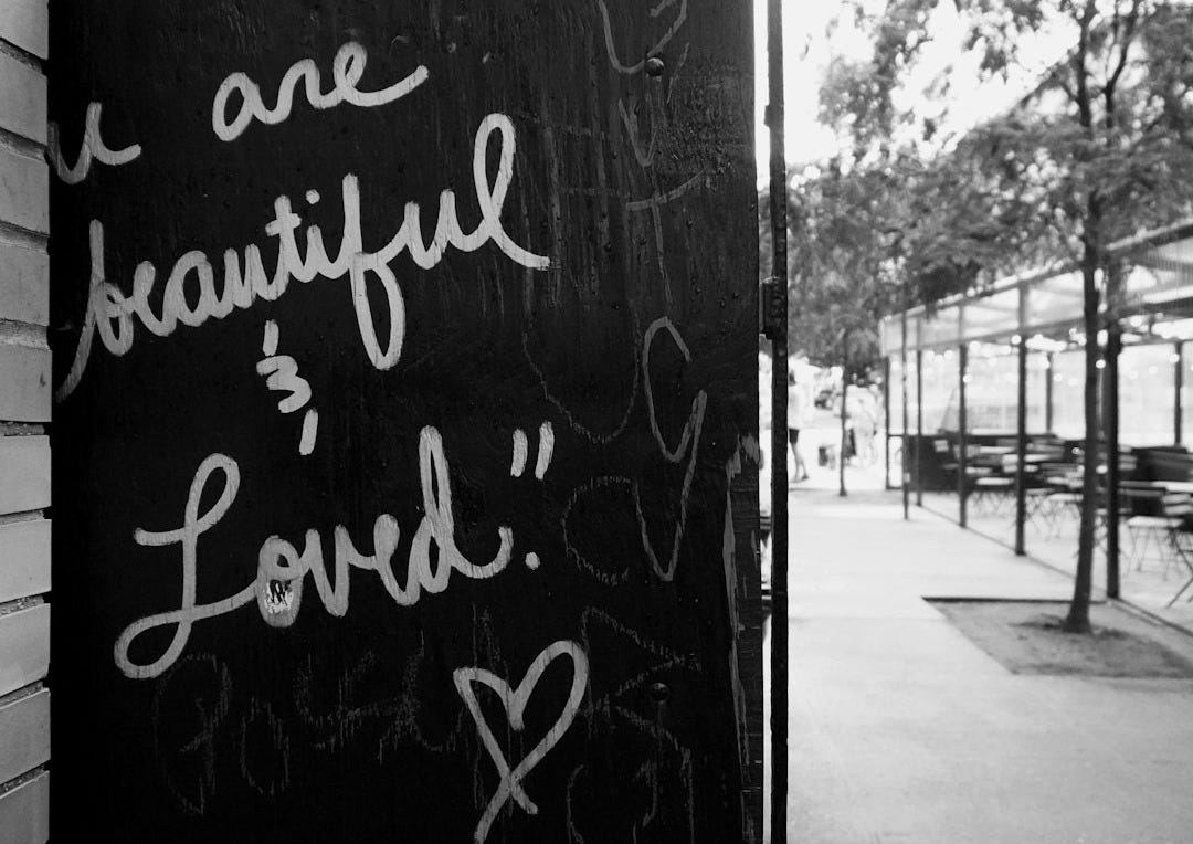 A black and white photo of a sign on the side of a building