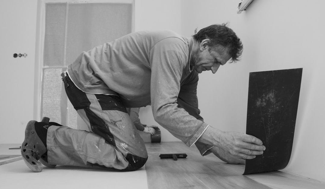 A man laying on the floor in a room A man laying on the floor in a room