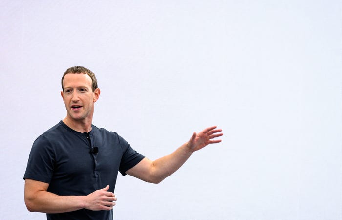 Tech CEO Mark Zuckerberg extending his arm in front of white background at Meta Connect event in California in September 2023.