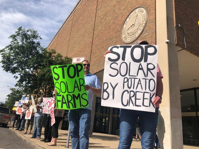 Residents protest the solar farms that Hexagon Energy is planning as they line up by the County-City Building in South Bend on June 11, 2024. Residents protest the solar farms that Hexagon Energy is planning as they line up by the County-City Building in South Bend on June 11, 2024.