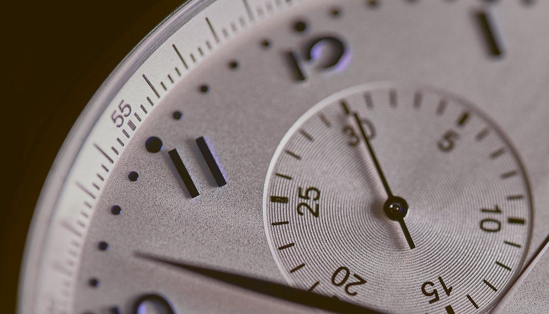 a close up of a silver watch face a close up of a silver watch face