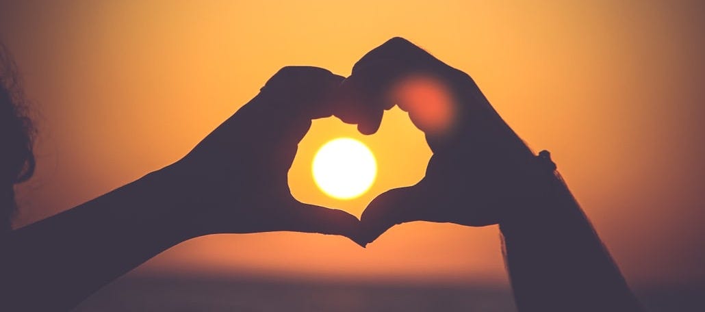 silhouette of person's hands forming heart silhouette of person's hands forming heart