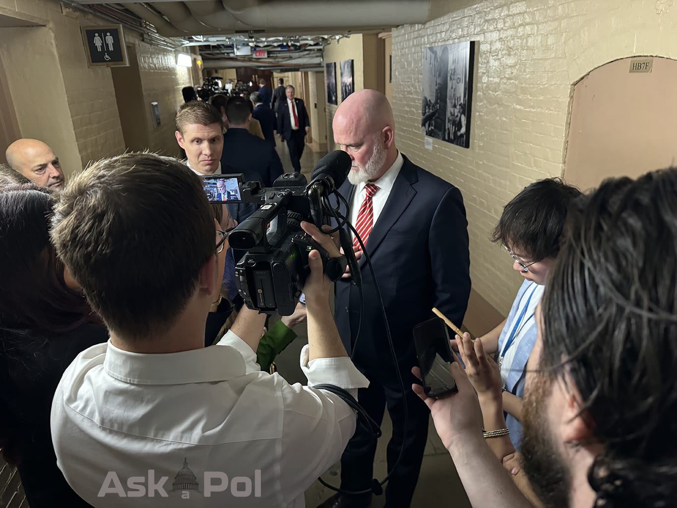Reporters and producers record their interview with a Congressman in a basement hallway. Photo Matt Laslo © www.askapol.com 
