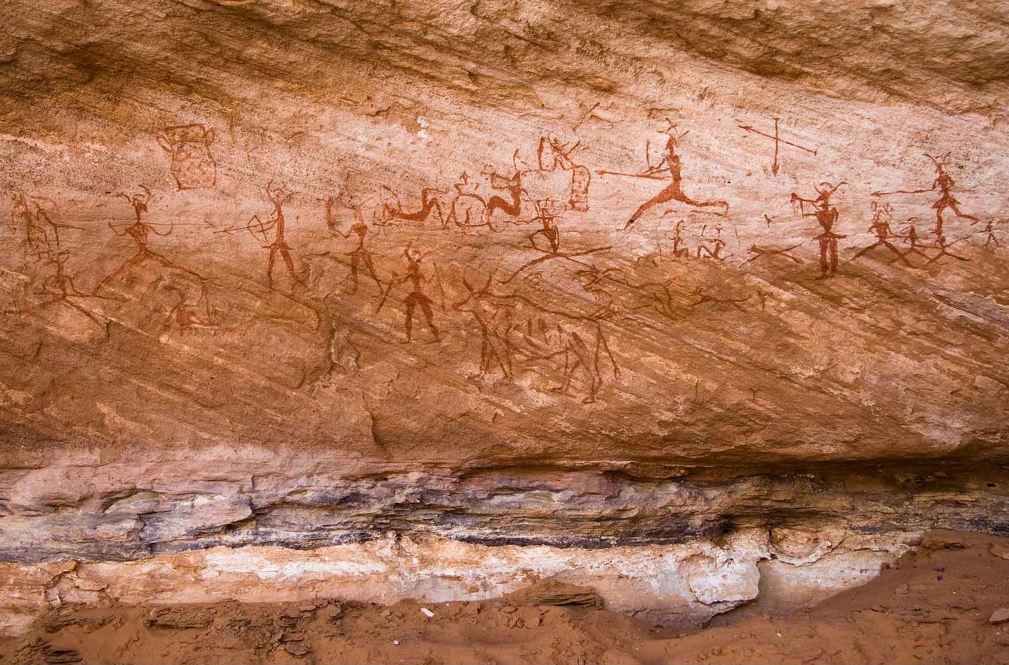 Pictograph showing human figures with bow and arrow and herd animals Pictograph showing human figures with bow and arrow and herd animals