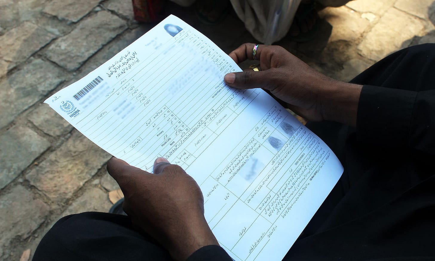 Qamar Abbas shows his wife's CNIC form. — Photo by author