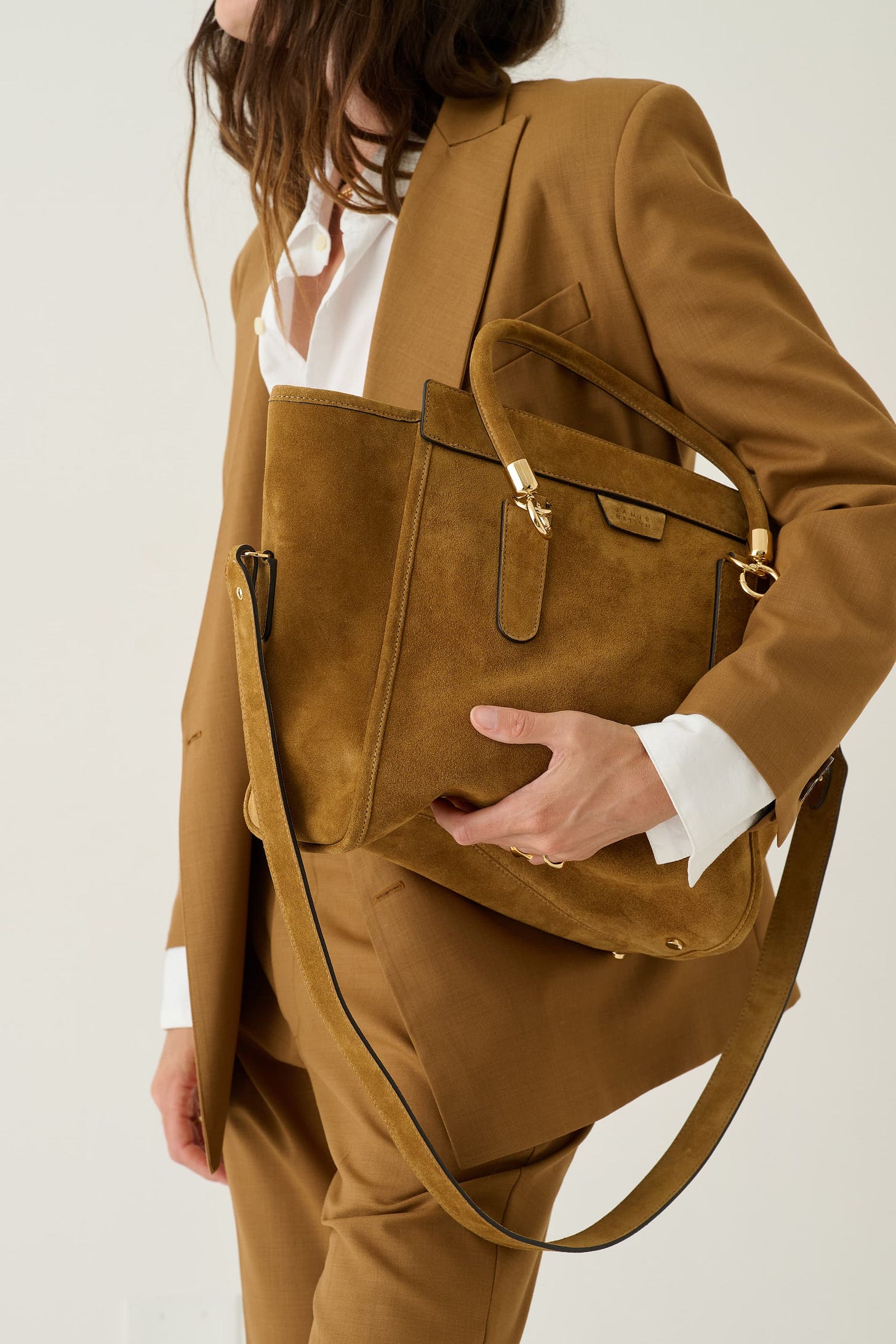 women crouching in burgundy shirt